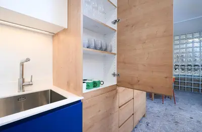 a kitchen with a sink and wooden cabinets at Petka apartments in Ljubljana