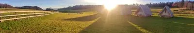 two sailboats in a field with the sun shining at Glamp Pr Kuzuc in Cerklje na Gorenjskem