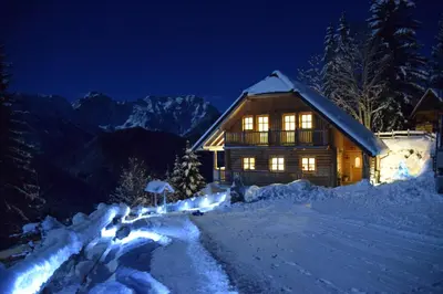 a log cabin in the snow at night at Holiday chalet 