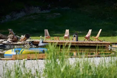 a group of lawn chairs and umbrellas on a dock at Holiday chalet 