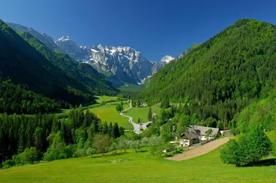 a green valley with a river and mountains at Holiday chalet 