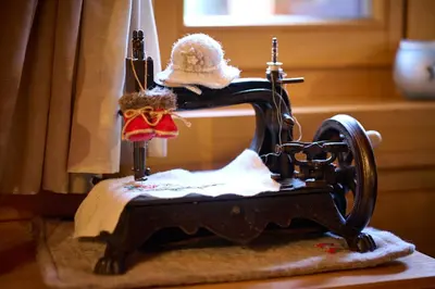 an old fashioned sewing machine with a hat on it at Holiday chalet 