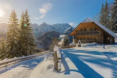 a log cabin in the mountains in the snow at Holiday chalet 