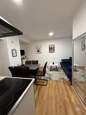 a kitchen and living room with a table and chairs at Apartmaji MAS 1 in Ljubljana