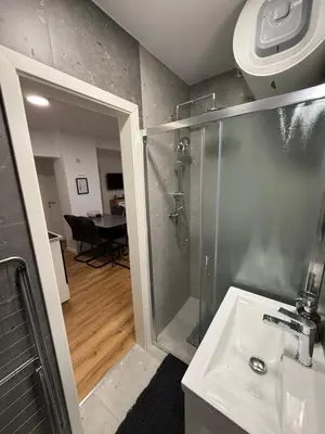 a bathroom with a shower and a sink at Apartmaji MAS 1 in Ljubljana