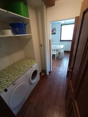 a washing machine in a room with a table at Private house near Terme Čatež in Cerklje ob Krki