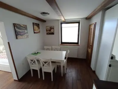 a dining room with a white table and chairs at Private house near Terme Čatež in Cerklje ob Krki