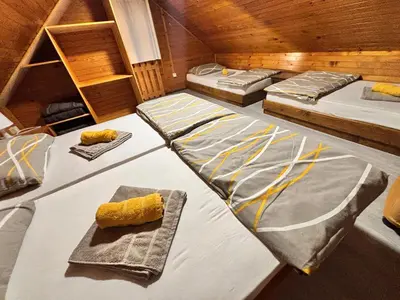 a room with three beds and a plate of food at Oddam hiško Lipa Čatež - Čateške Toplice in Brežice