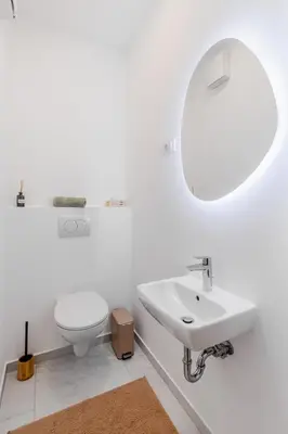 a white bathroom with a sink and a toilet at Family Apartment Bovec in Bovec