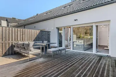 a patio with a table and chairs on a deck at Family Apartment Bovec in Bovec