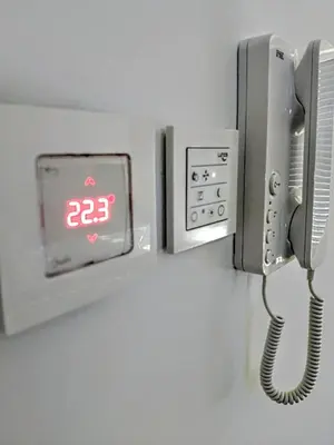 a phone is attached to a wall at Apartments Ana in Maribor