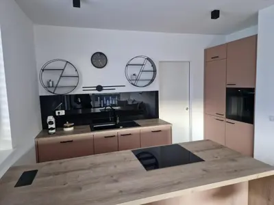 a kitchen with a wooden table and a sink at Apartments Ana in Maribor