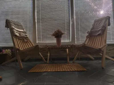 two rocking chairs and a table in a room at Apartma Ariana in Loče pri Poljčanah