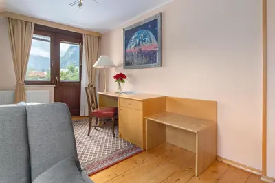 a living room with a desk and a couch at Apartment Jakovc in Bohinj