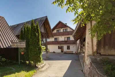 a street sign in front of a building with a house at Apartment Jakovc in Bohinj