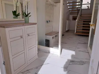 a bathroom with a vanity and a tile floor at Apartma Gašper in Šentjur