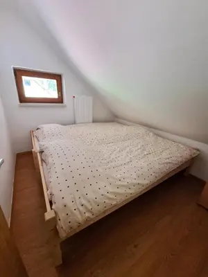 a small bed in a corner of a room at Apartment Rogla Residence in Vitanje