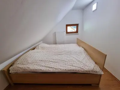 a bedroom with a bed in a attic at Apartment Rogla Residence in Vitanje