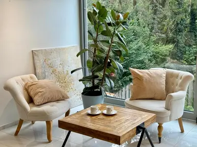 a living room with two chairs and a coffee table at Vila Brinje Private room with spa in Dol pri Ljubljani