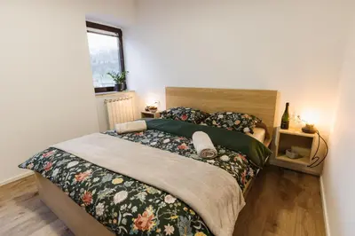 a bedroom with a large bed and a window at Apartma Castrum Vini in Ajdovščina