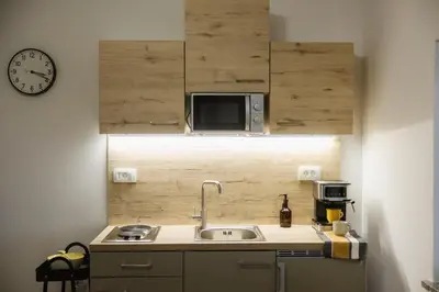 a kitchen with a sink and a microwave at Apartma Castrum Vini in Ajdovščina