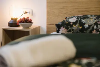 a bowl of fruit on a table next to a lamp at Apartma Castrum Vini in Ajdovščina
