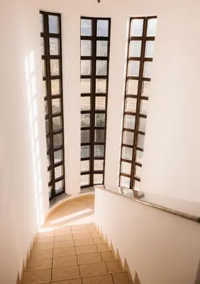 a room with four windows and a tiled floor at Apartma Castrum Vini in Ajdovščina