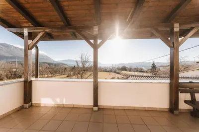 a view from the balcony of a house with mountains in the background at Apartma Castrum Vini in Ajdovščina