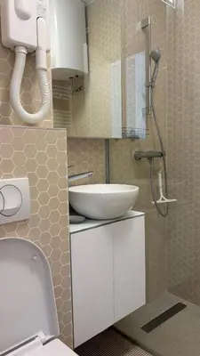 a bathroom with a white sink and a shower at Studio apartma Rimljanka in Ptuj