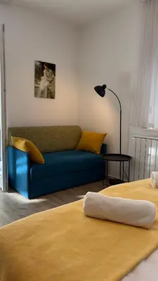 a living room with two beds and a couch at Studio apartma Rimljanka in Ptuj