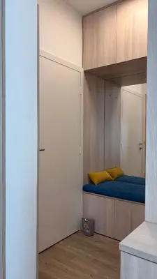 a small bedroom with a bed and a closet at Studio apartma Rimljanka in Ptuj
