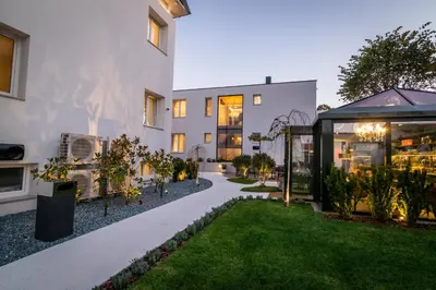 an exterior view of a building with a garden at Beatrice - Boutique Apartments Resort in Ljubljana