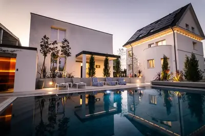 a house with a swimming pool in front of a house at Beatrice - Boutique Apartments Resort in Ljubljana
