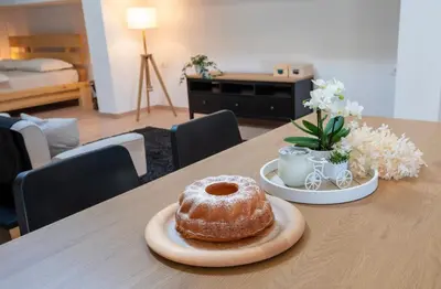 a pastry is sitting on a wooden table at Horse Whispering Ranch apartma in Ilirska Bistrica
