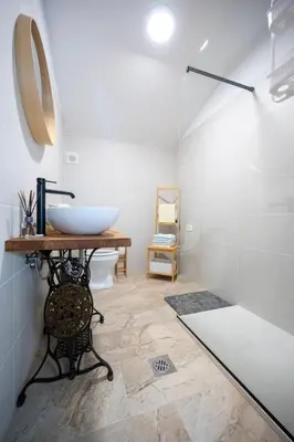 a bathroom with a sink and a toilet and a mirror at Horse Whispering Ranch apartma in Ilirska Bistrica