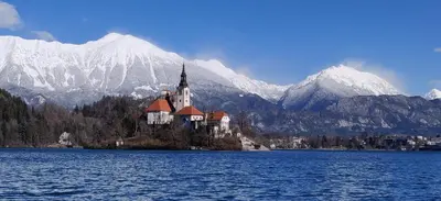 a castle on an island in the middle of a lake at Cozy rooms in the center of Bled by the lake #1 in Bled
