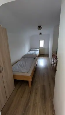 a small bedroom with a bed and a window at Cozy rooms in the center of Bled by the lake #1 in Bled