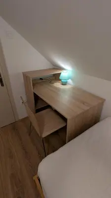 a desk with a lamp and a bed in a room at Cozy rooms in the center of Bled by the lake #1 in Bled