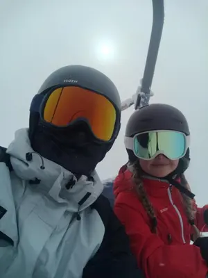 two people wearing helmets and goggles on a ski lift at Cozy rooms in the center of Bled by the lake #1 in Bled