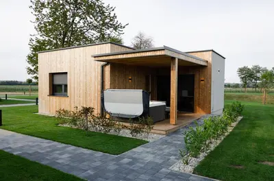 a small house with a large tub in a yard at Oaza Luxury Glamping Resort in Moravske Toplice