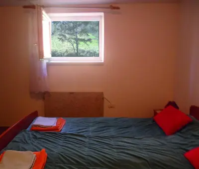 a bedroom with a bed and a window at Farm Stay Ferjančič in Vipava