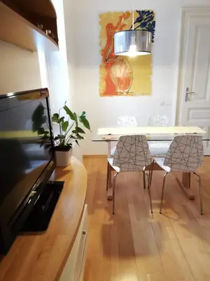 a dining room with a table and chairs at Dimora Apartments with free parking in Ljubljana