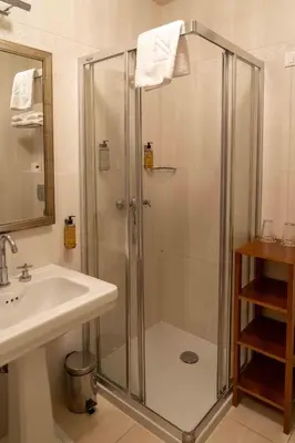 a bathroom with a shower and a sink at Hotel Ptuj in Ptuj