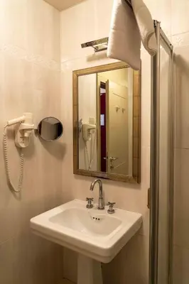 a bathroom with a sink and a mirror at Hotel Ptuj in Ptuj