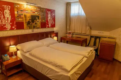 a bedroom with a large bed in a room at Hotel Ptuj in Ptuj