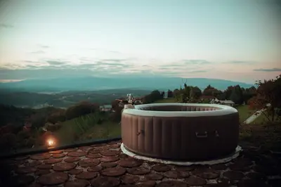 a hot tub sitting on top of a roof at SkyView Dežno in Makole
