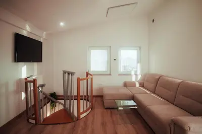 a living room with a couch and a flat screen tv at SkyView Dežno in Makole