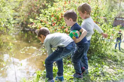 a group of three young boys playing with a ball at Farm Soržev mlin in Nova Cerkev