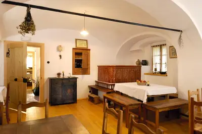 a kitchen and dining room with a table and chairs at Farm Soržev mlin in Nova Cerkev