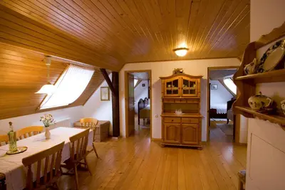 a living room with a table and a dining room at Farm Soržev mlin in Nova Cerkev